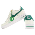 White and green low-top sneakers with diagonal swoosh and “AIR” branding