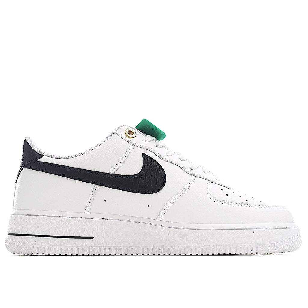 White leather sneaker with black swoosh and green collar pull tab
