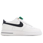 White leather sneaker with black swoosh and green collar pull tab
