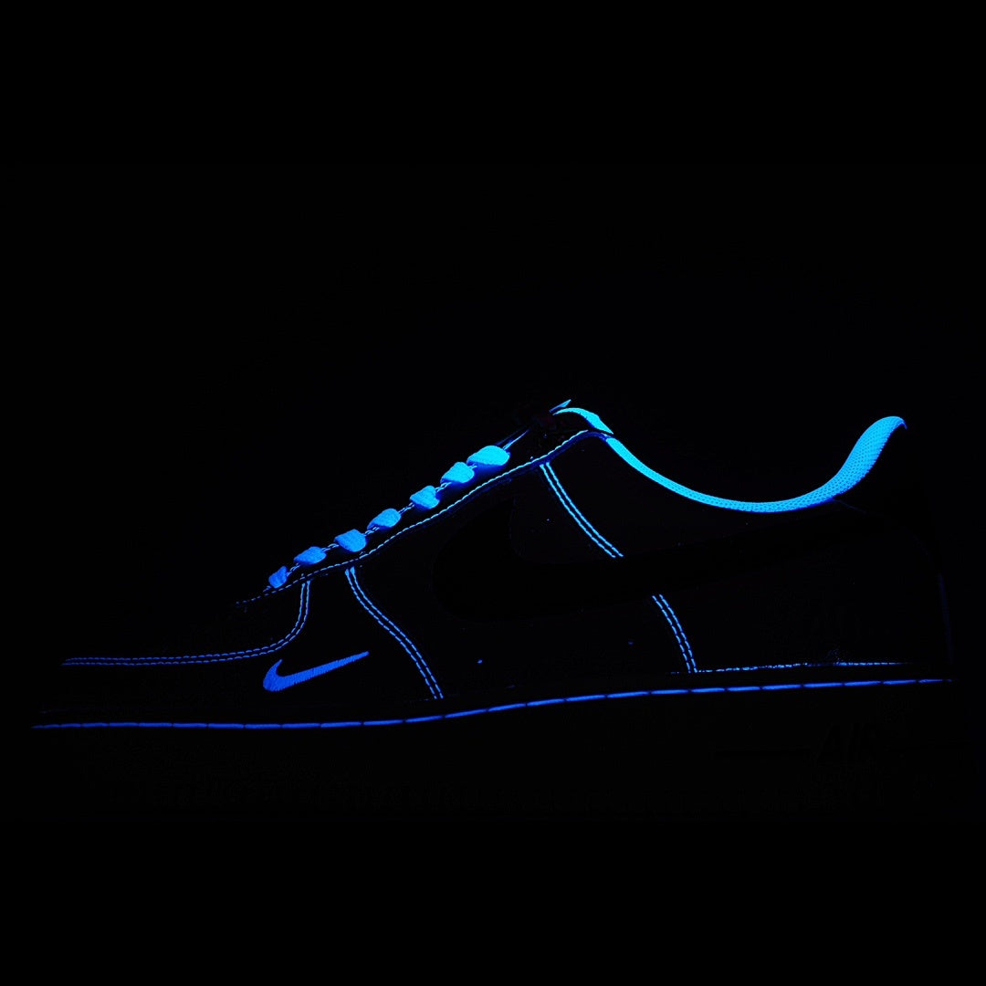 Low-top sneaker with blue neon outline and dark upper