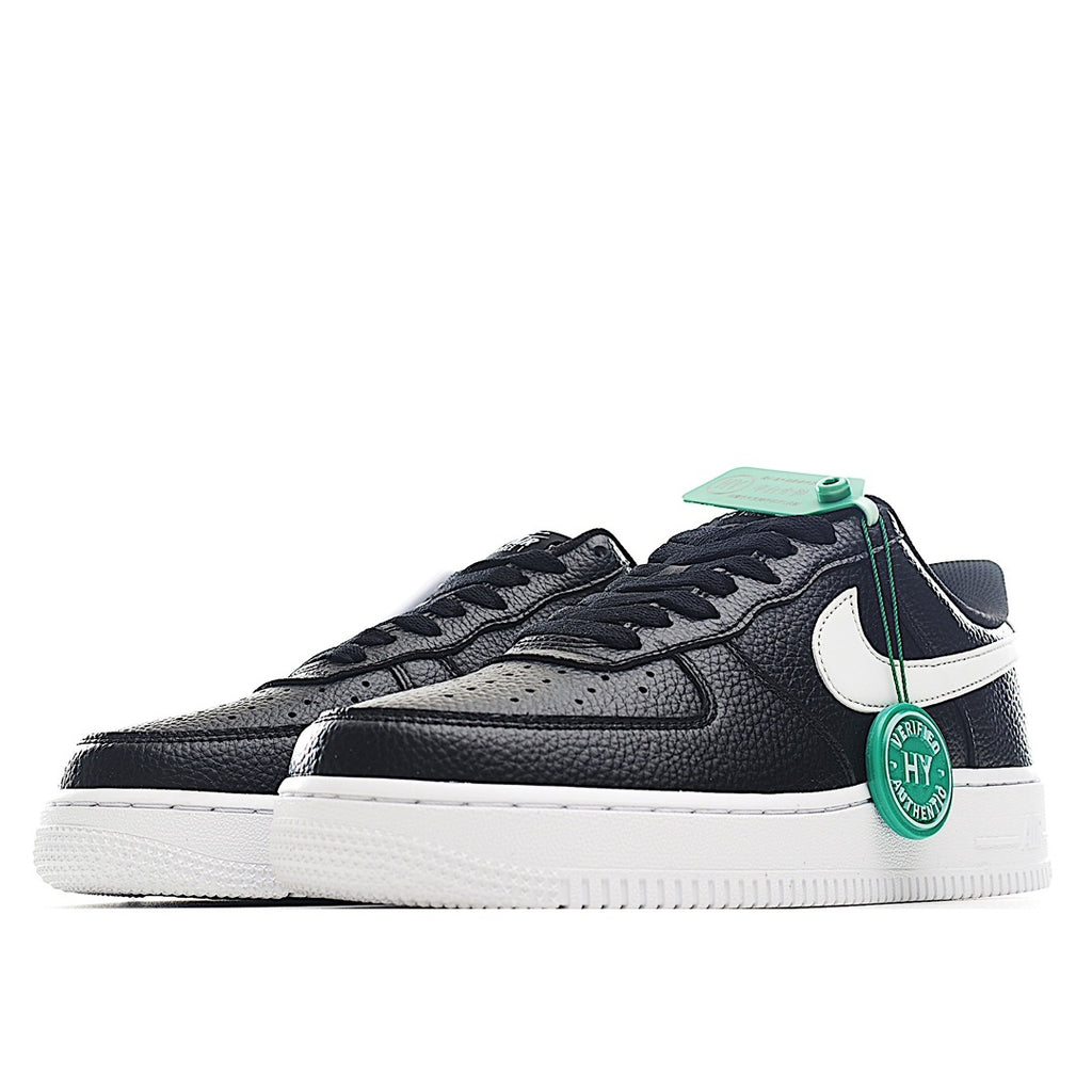 Side view Nike Air Force 1 sneakers in black/navy with white swoosh and green HY tag