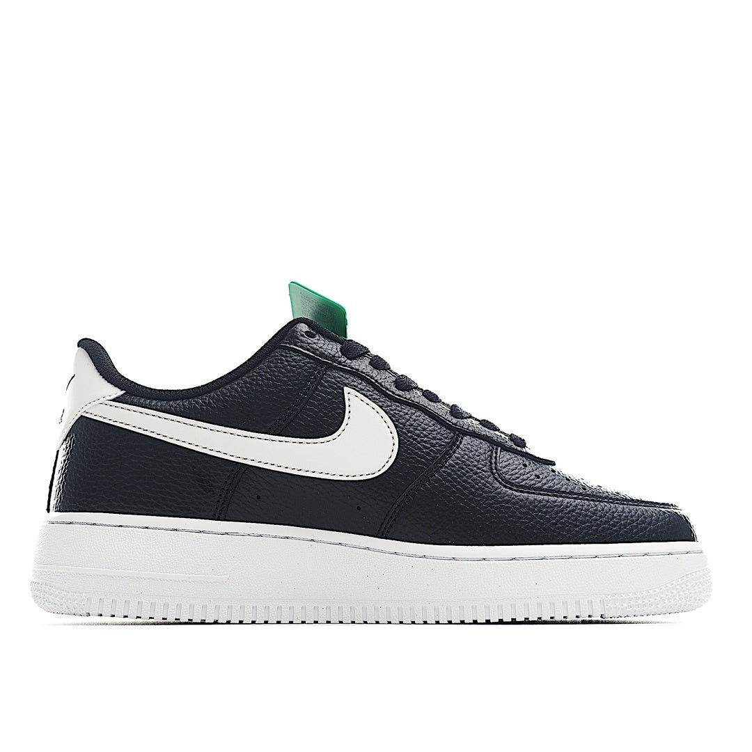Nike Air Force 1 low-top in black/navy with white swoosh and green lace tag