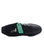 Nike Air Force 1 shoe with black/navy upper, green tag, and laced interior