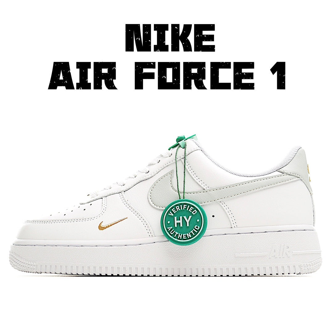White Nike Air Force 1 sneakers with green lace accents and gold side swoosh