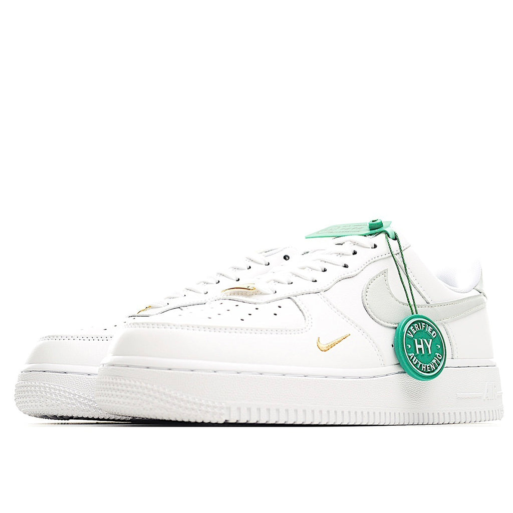 White Nike Air Force 1 sneakers with green laces, side swoosh, and white rubber sole
