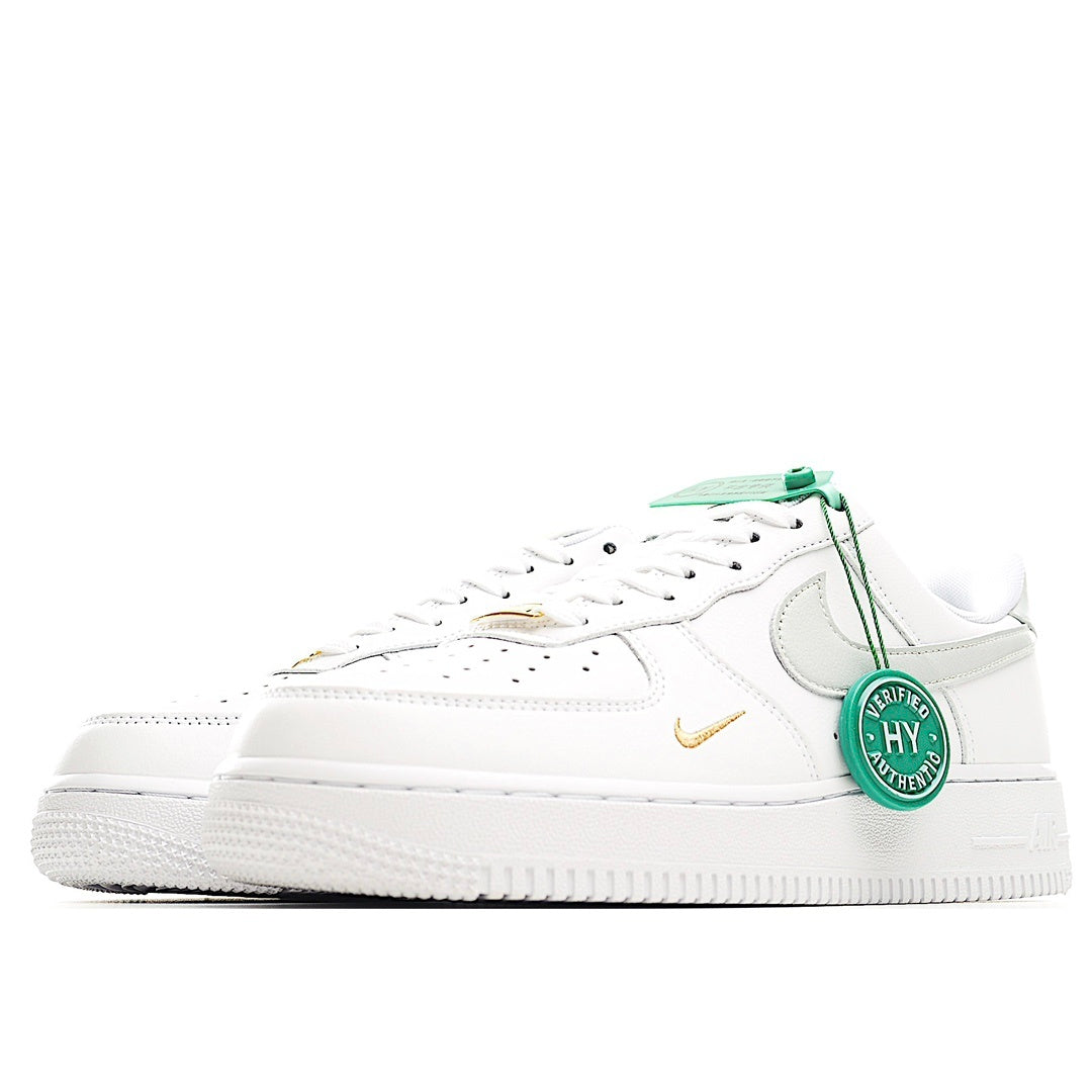 White Nike Air Force 1 sneakers with green laces, side swoosh, and white rubber sole
