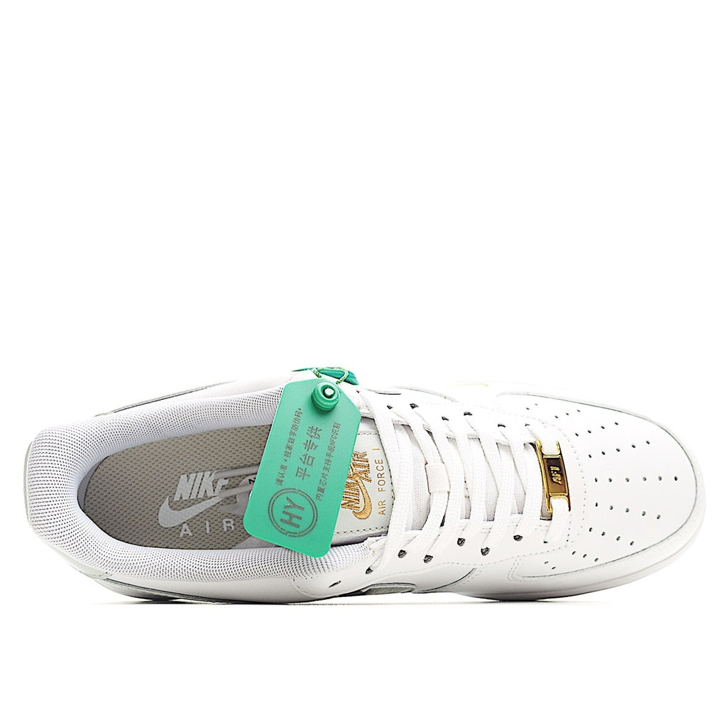 White Nike Air Force 1 sneakers with gray lining and green inner tag over the tongue