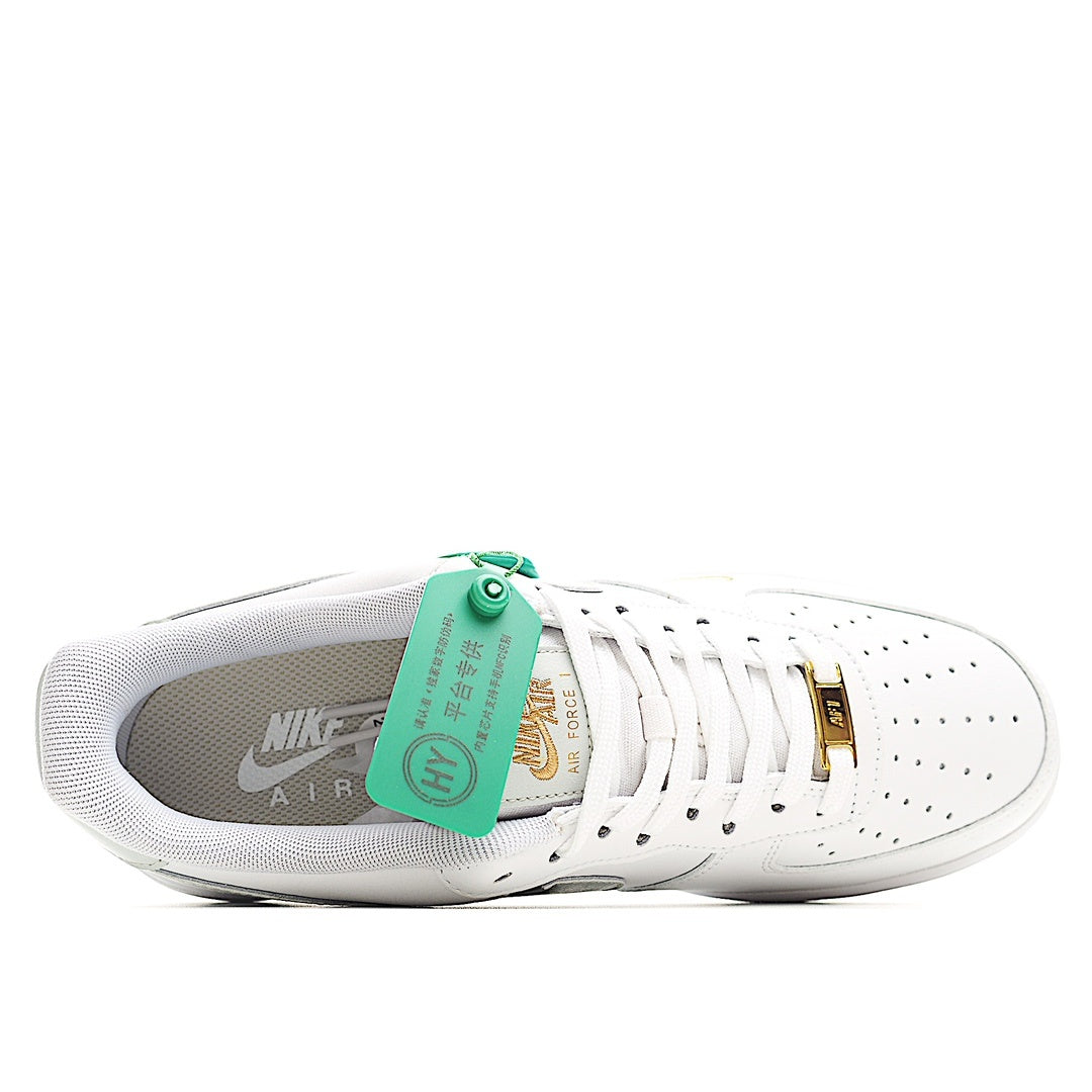 White Nike Air Force 1 sneakers with gray lining and green inner tag over the tongue