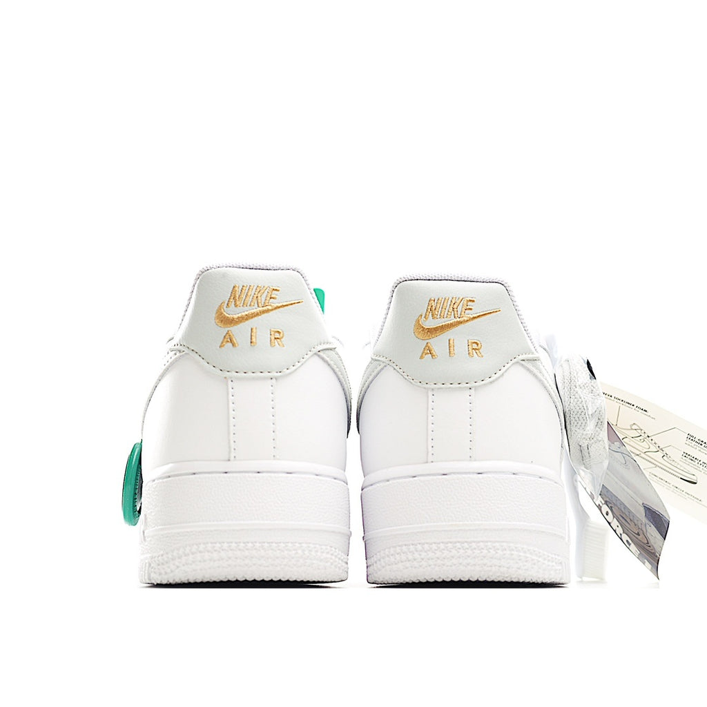 White Nike Air Force 1 sneakers with green heel pull tab and Air branding on the back
