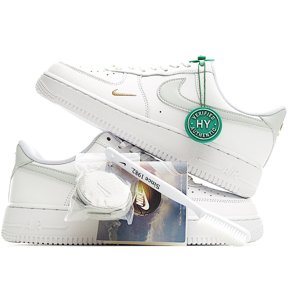 White Nike Air Force 1 sneakers with green Verified tag and gold side swoosh