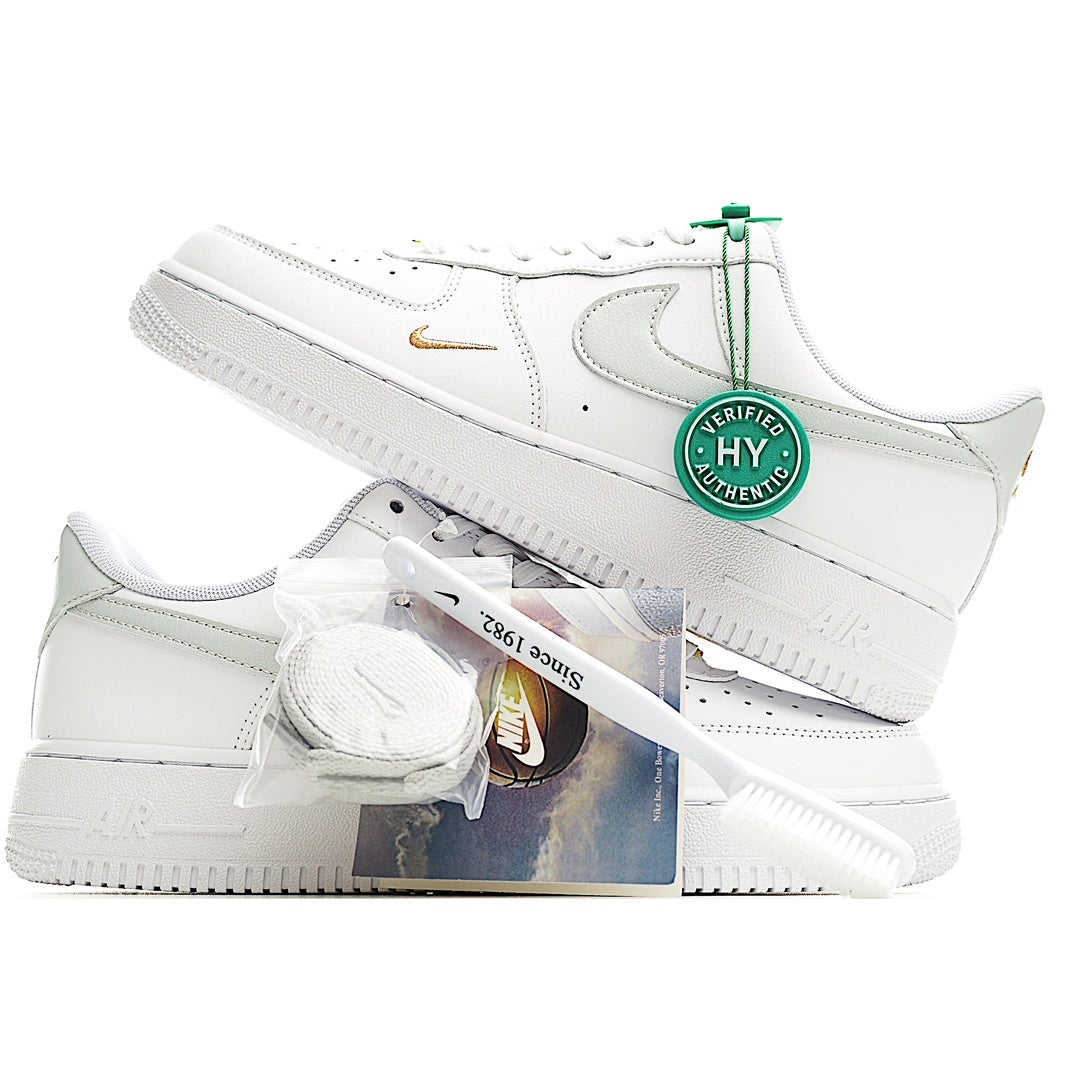 White Nike Air Force 1 sneakers with green Verified tag and gold side swoosh