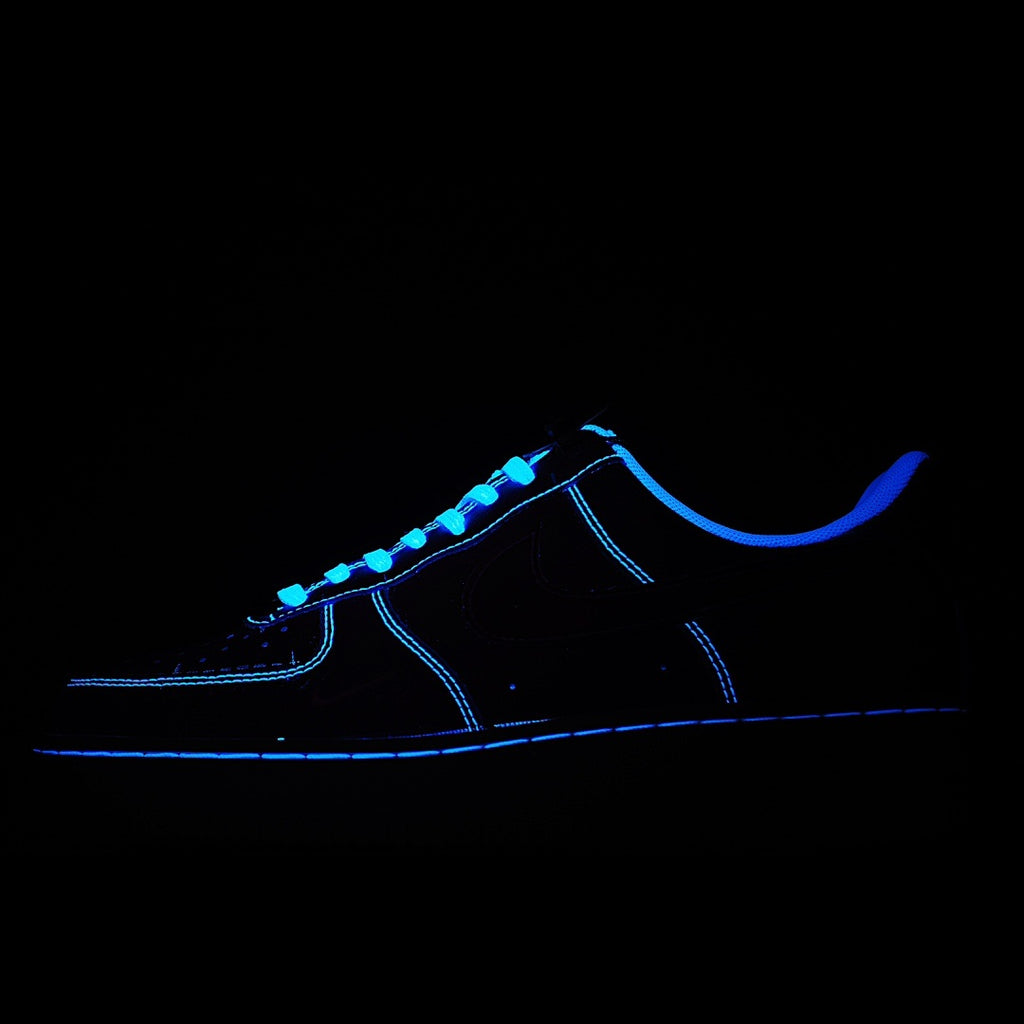 Dark Nike Air Force 1 sneakers with blue glowing laces and side stitching detail