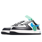 Low-top sneaker side view, black and white with blue swoosh; turquoise tag on laces.