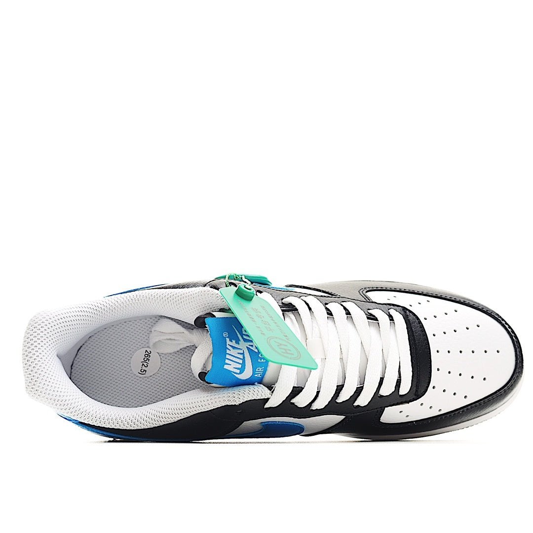 Low-top sneaker interior view with white laces, black upper, light blue accents; green tag.