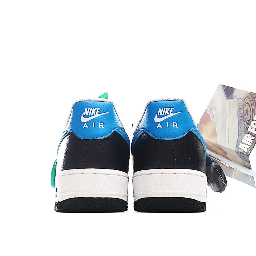 Pair of low-top sneakers with white midsoles, black uppers, and blue heel tabs.