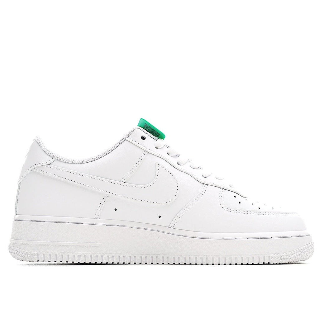 Nike Air Force 1 low-top sneaker, white leather side view with green lace hardware