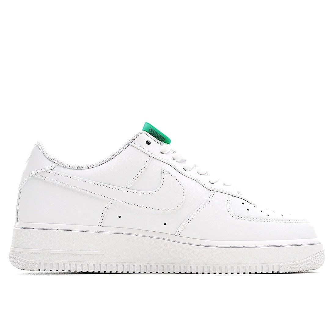 Nike Air Force 1 low-top sneaker, white leather side view with green lace hardware