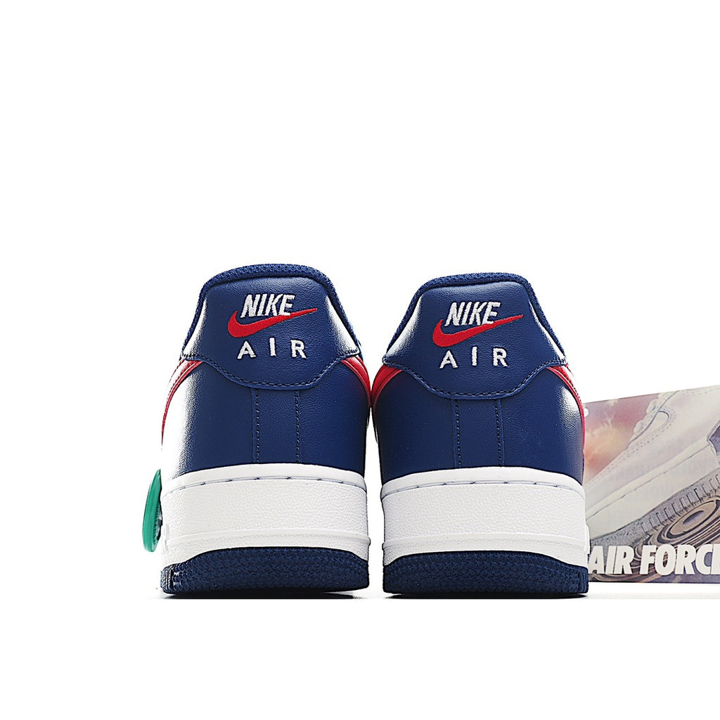 Pair of blue sneakers with white midsoles, red heel accents, and Nike Air branding