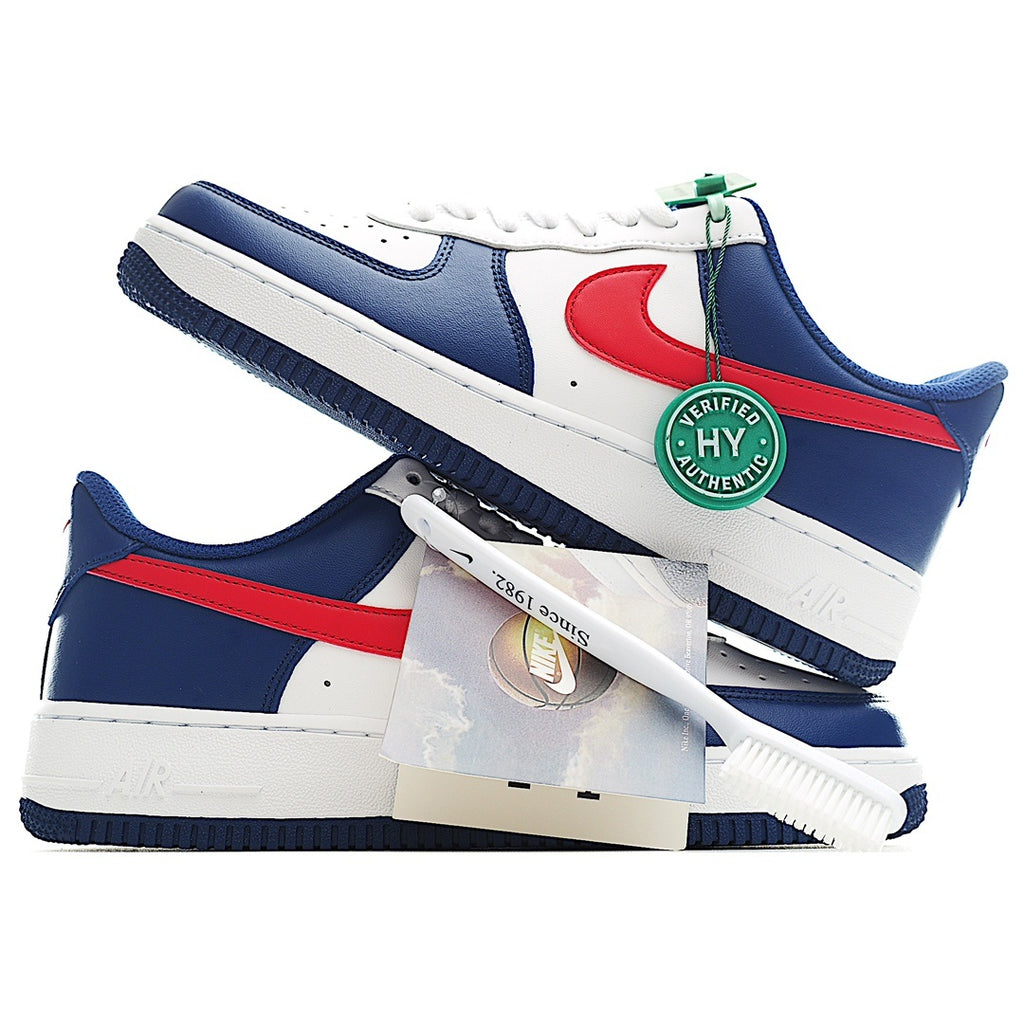 Blue and white low-top sneakers with red swoosh, green lace tag, and white laces