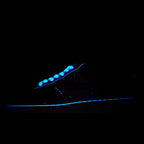 Dark blue sneaker with glowing blue trim and swoosh detail