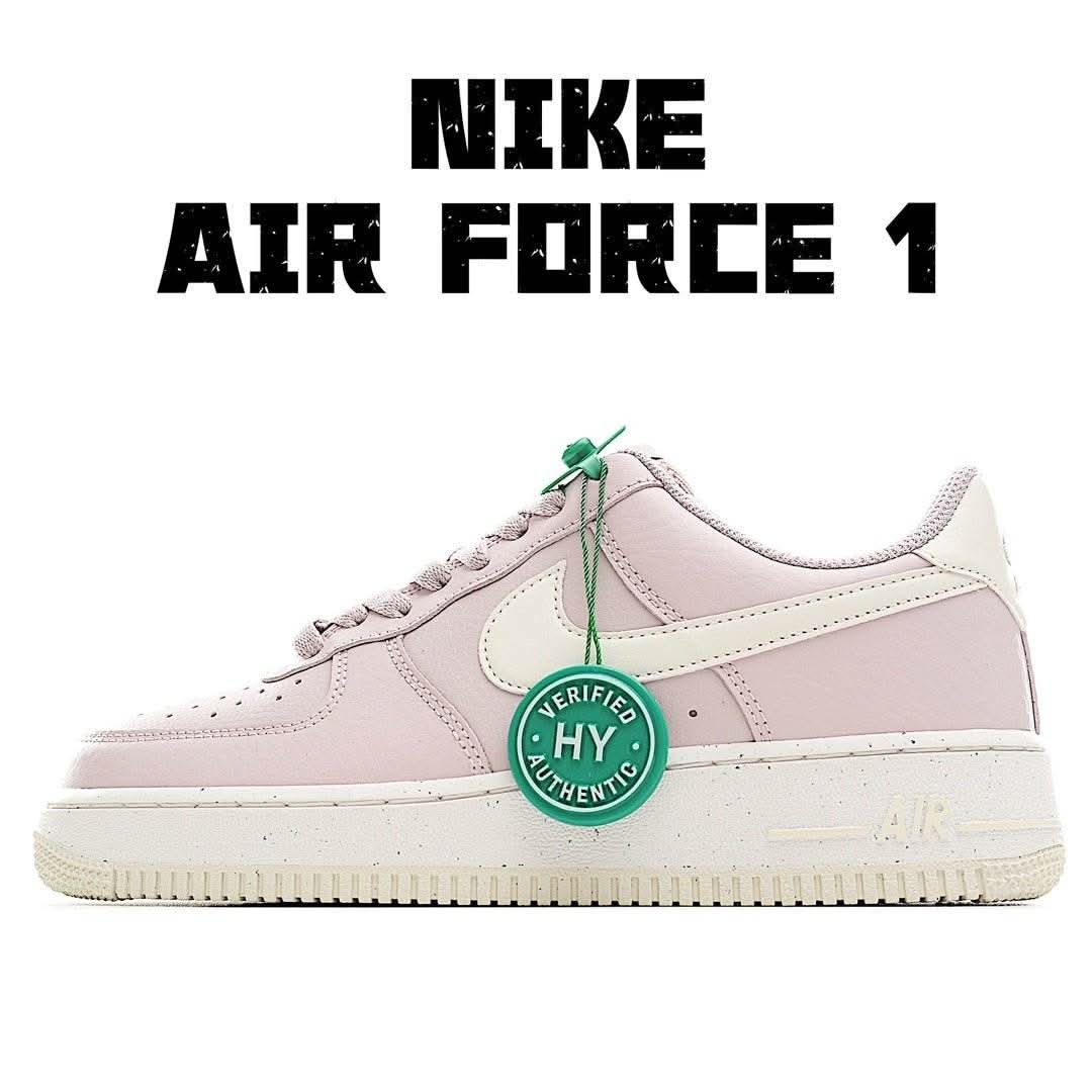 Pink low-top sneakers with white swoosh, green tag, lace-up and perforated toe