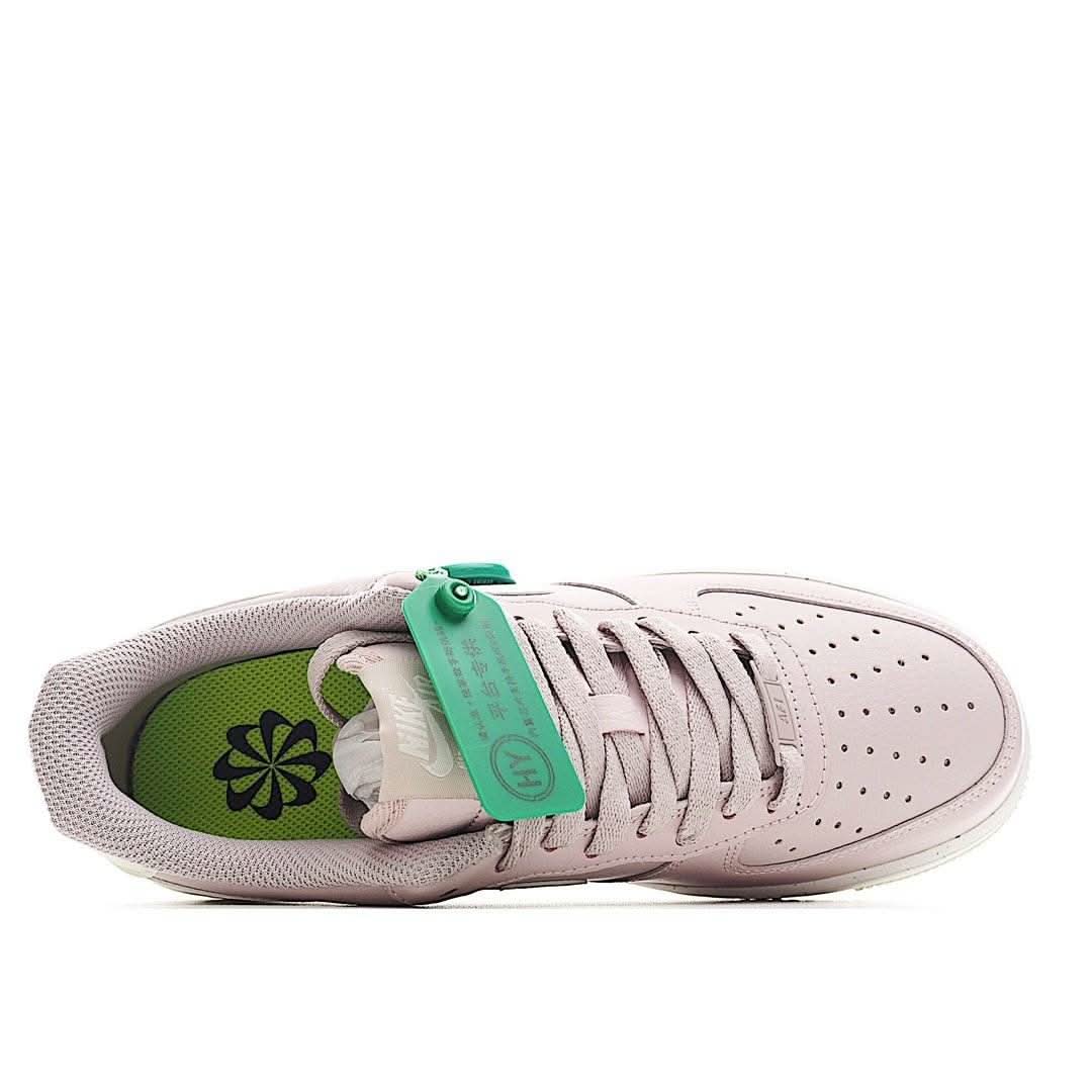 Pink lace-up sneaker with green inner lining and exposed tongue label