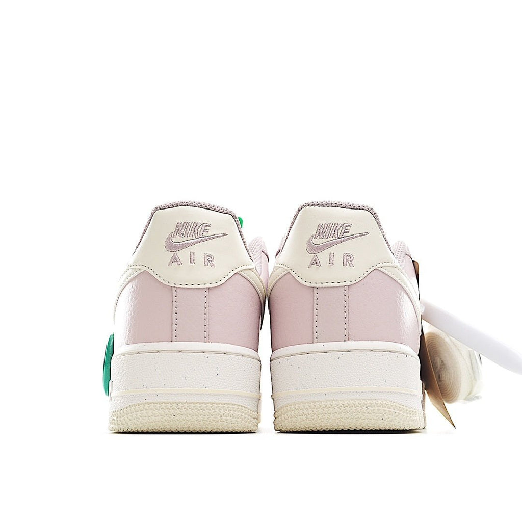 Pink high-collar sneakers with Nike Air heel text and green heel pull