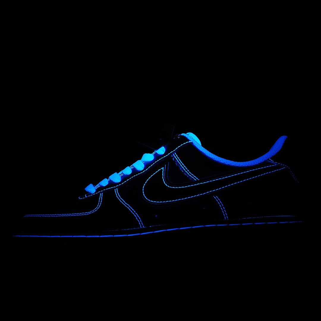 Dark blue low-top sneaker with black Nike swoosh and blue sole trim