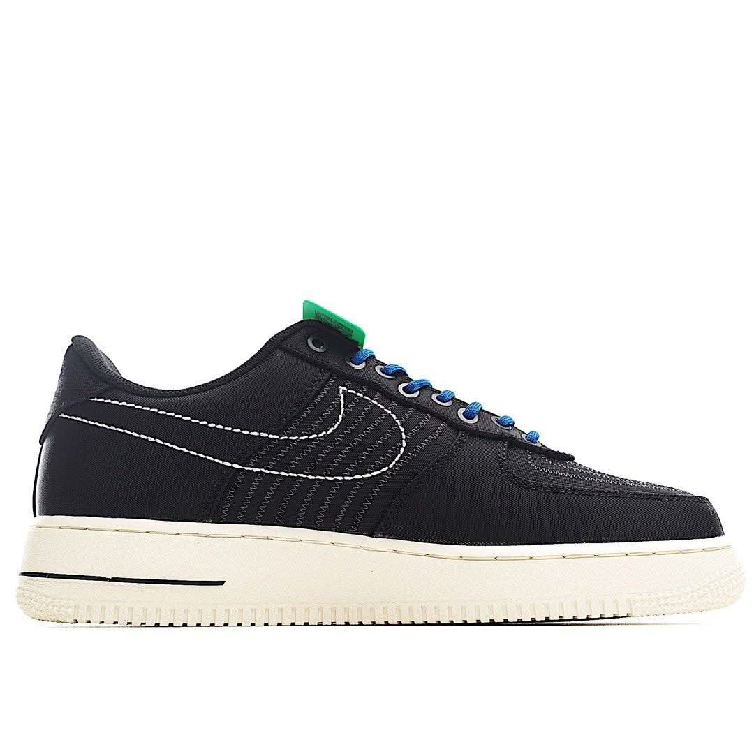 Black Nike Air Force 1 sneaker with blue laces, green heel accent, cream midsole