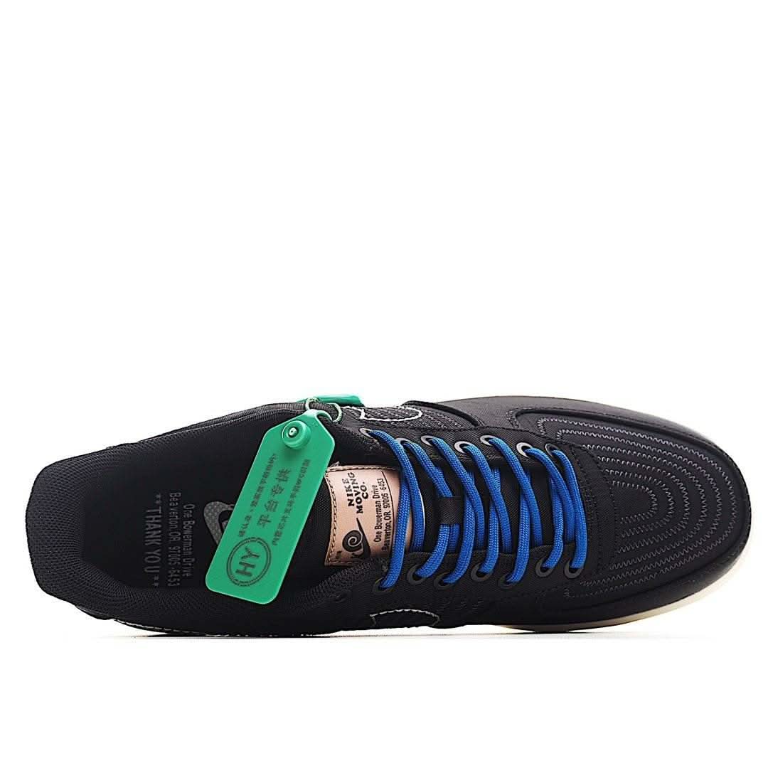 Black Nike Air Force 1 sneaker showing textured outsole and blue laces, green tag