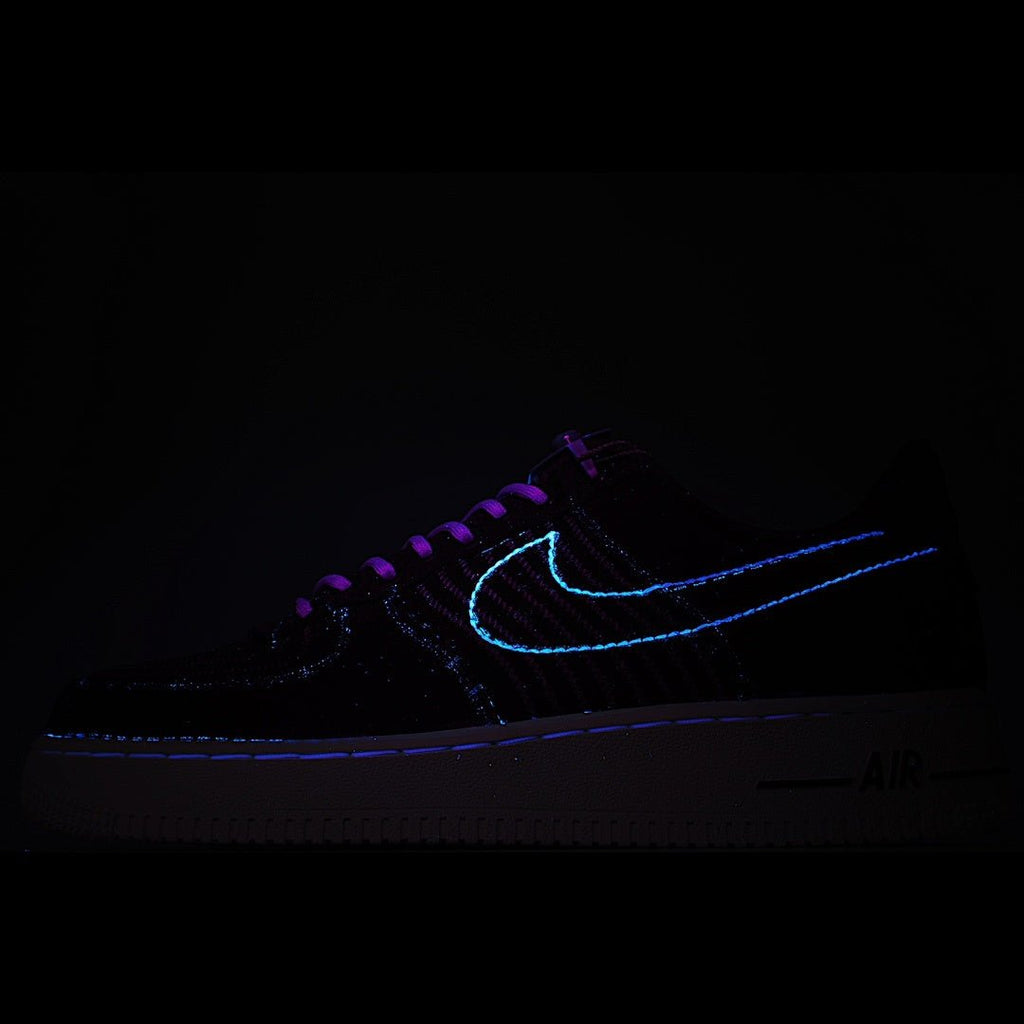 Dark sneakers with neon blue swoosh outline and laces