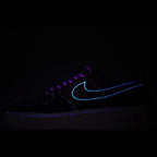 Dark sneakers with neon blue swoosh outline and laces