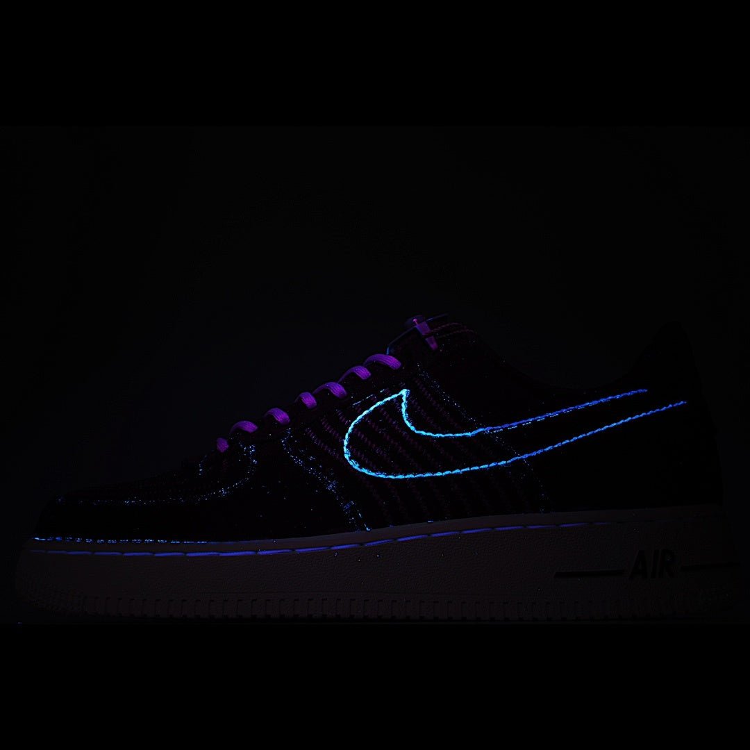 Dark sneakers with neon blue swoosh outline and laces