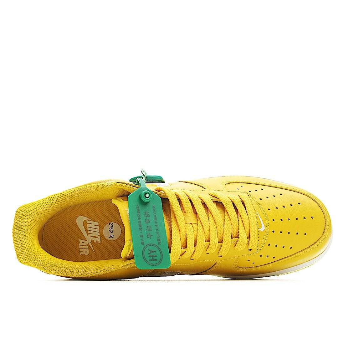 Yellow Nike Air Force 1 low-top sneakers with green inside tag, lace-up view