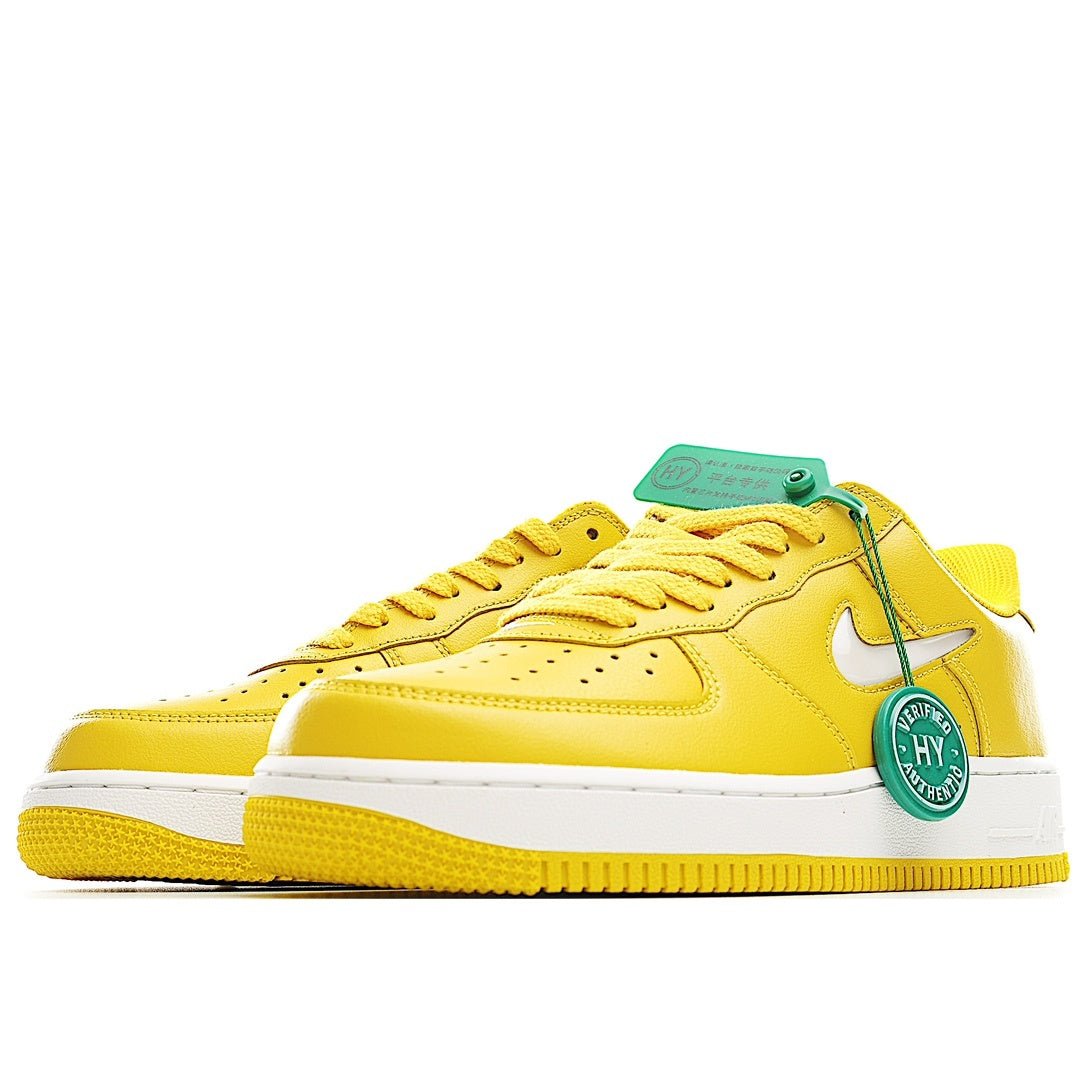 Yellow Nike Air Force 1 low-top sneaker side view with white swoosh and green details