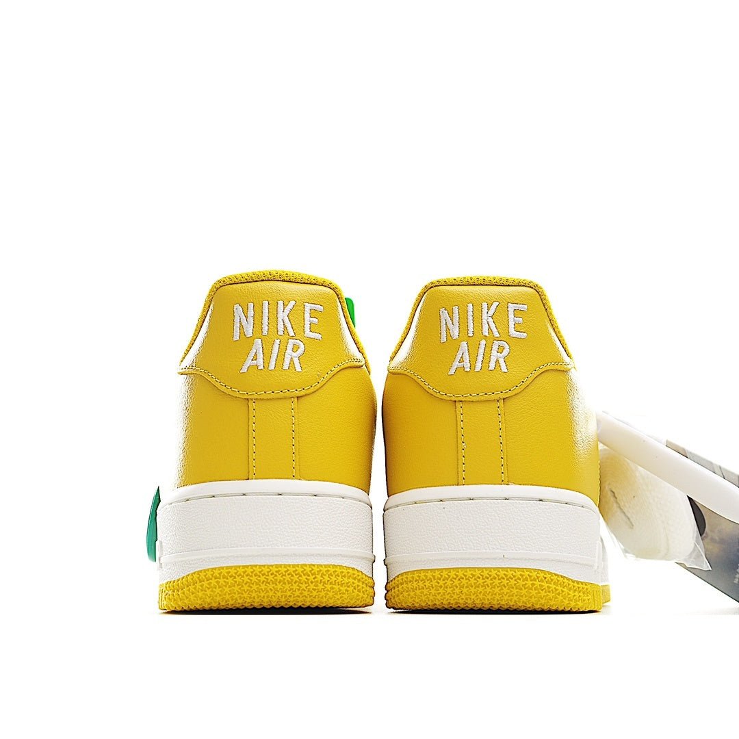 Yellow Nike Air Force 1 low-top sneakers, white midsole, green heel accents