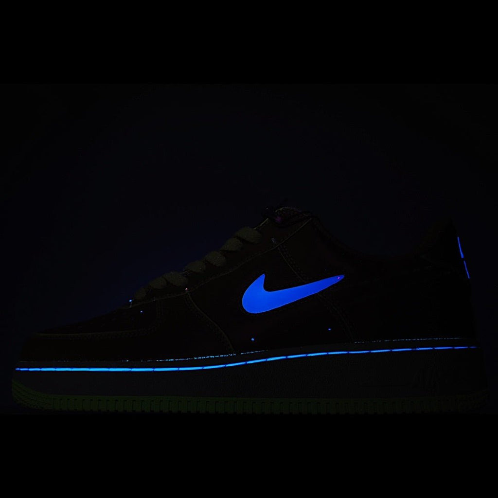 Black Nike low-top sneakers with bright blue swoosh accent
