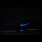 Black Nike low-top sneakers with bright blue swoosh accent