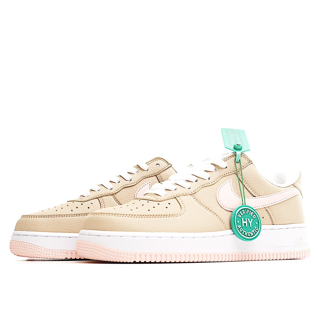 Beige low-top sneaker with white swoosh, mint HY tag, and pink outsole