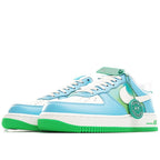 Pair of light blue low-top sneakers with white swoosh and green sole