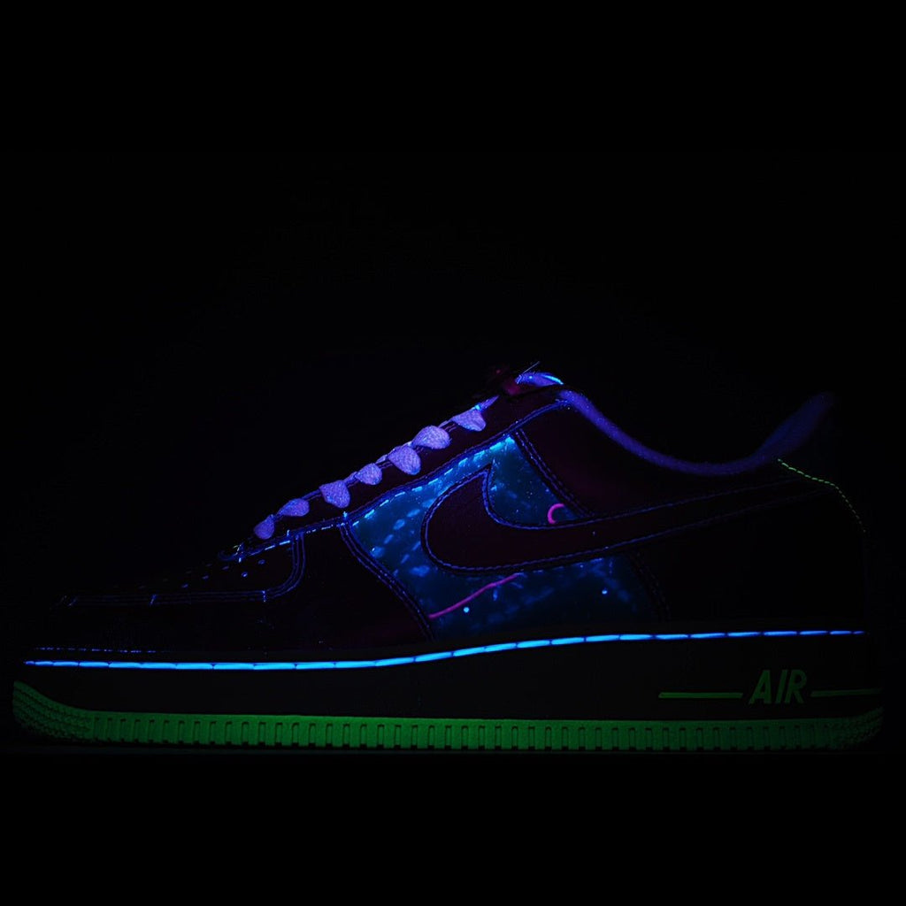 Low-top sneakers with neon blue and green glowing accents