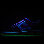 Low-top sneakers with neon blue and green glowing accents