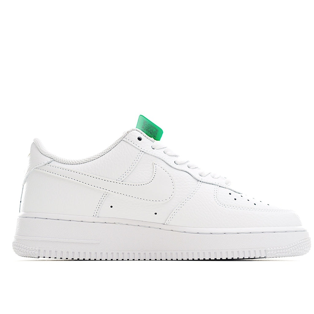 White Air Force 1 low-top sneaker front quarter view with green lace tab