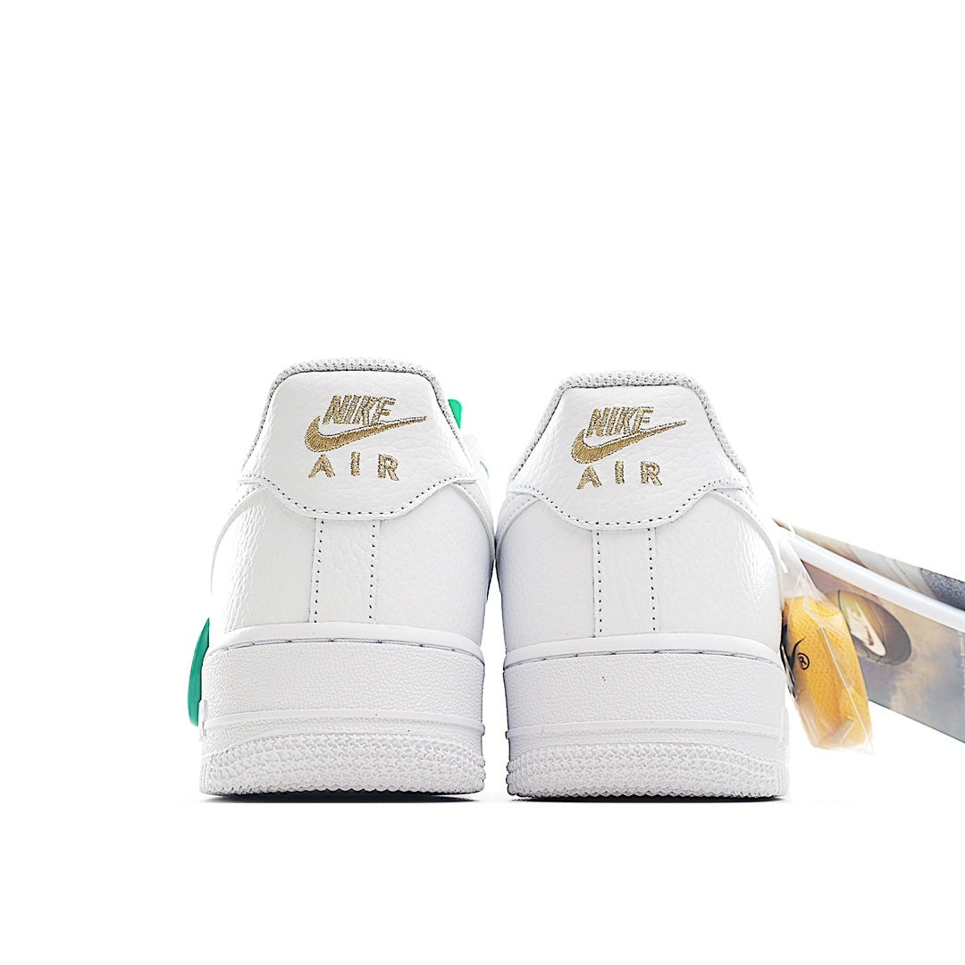 White Air Force 1 sneaker back view with Nike Air heel branding and green accents
