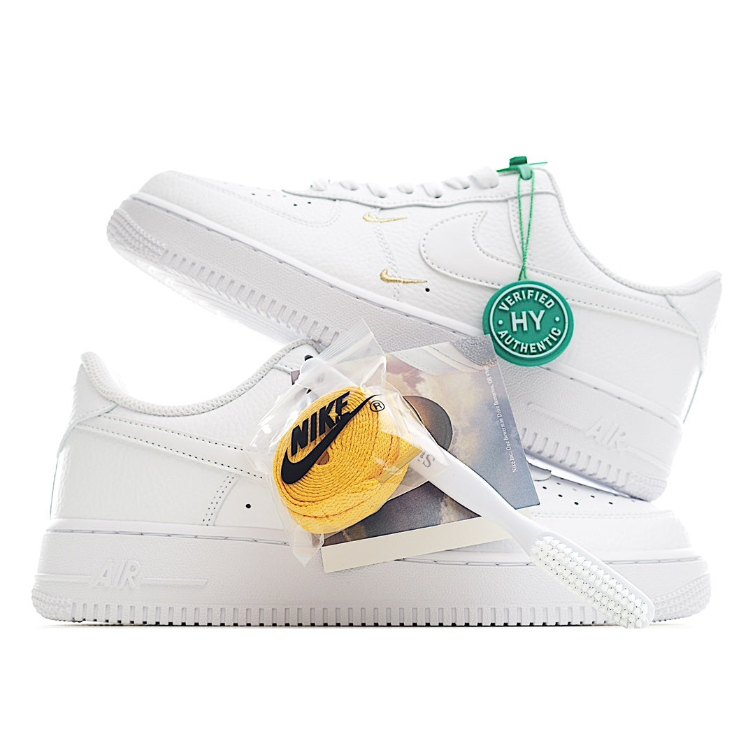 White Air Force 1 sneaker with green lace tag and gold swoosh on side