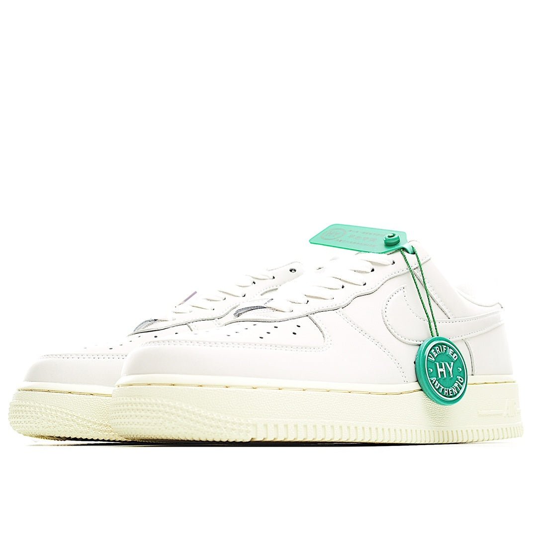 White low-top sneaker side view with green laces and hang tag