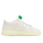 White low-top leather sneaker with green hang tag and cream sole