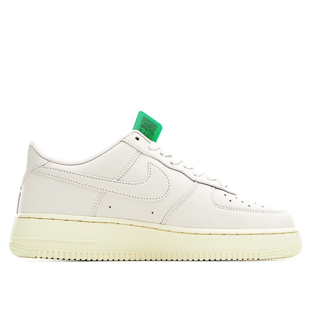 White low-top leather sneaker with green hang tag and cream sole