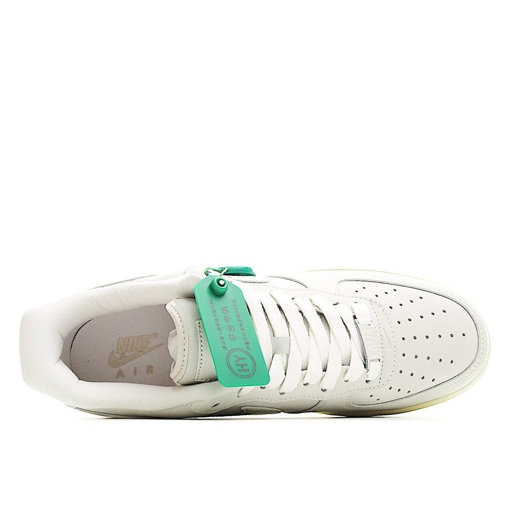 White low-top sneaker interior view with green tag and lace-up front