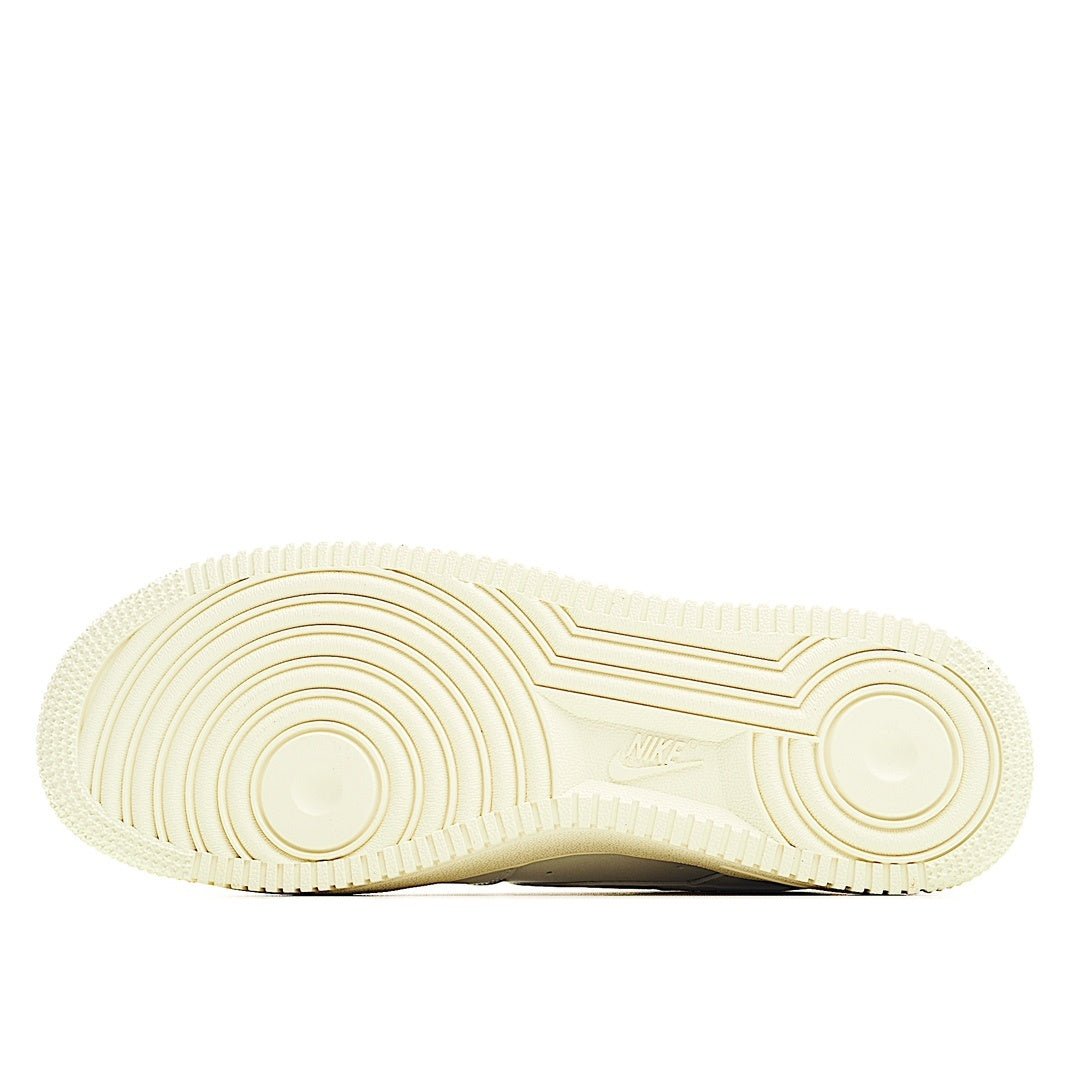 White rubber outsole with circular traction pattern and AIR logo
